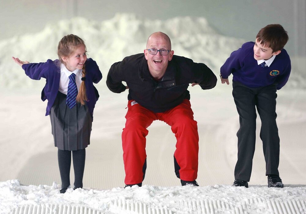 National Schools Snowsport Week ambassador Eddie the Eagle with Patrisia TJ from Yewtree Primary School Hemel Hempstead
