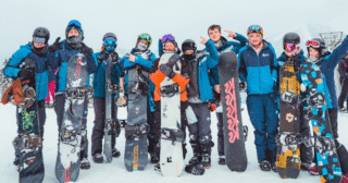 Skiers practising avalanche safety training with a mountain guide