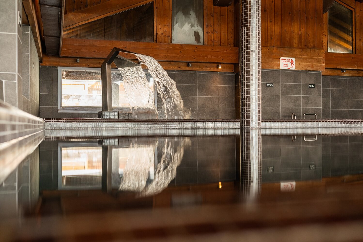 Indoor swimming pool with water feature at Chalet Hotel L'Ecrin, Tignes