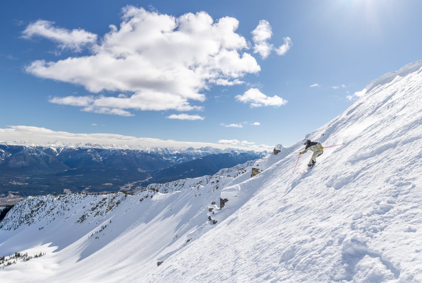 Skier on steep in-bounds terrain at Kicking Horse Mountain Resort above the Columbia Valley