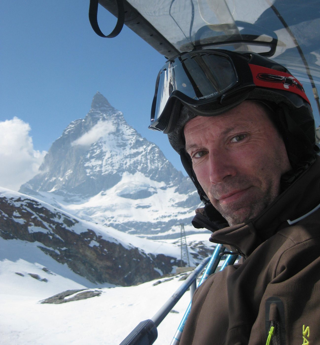 Patrick Thorne on a chairlift with the Matterhorn behind him