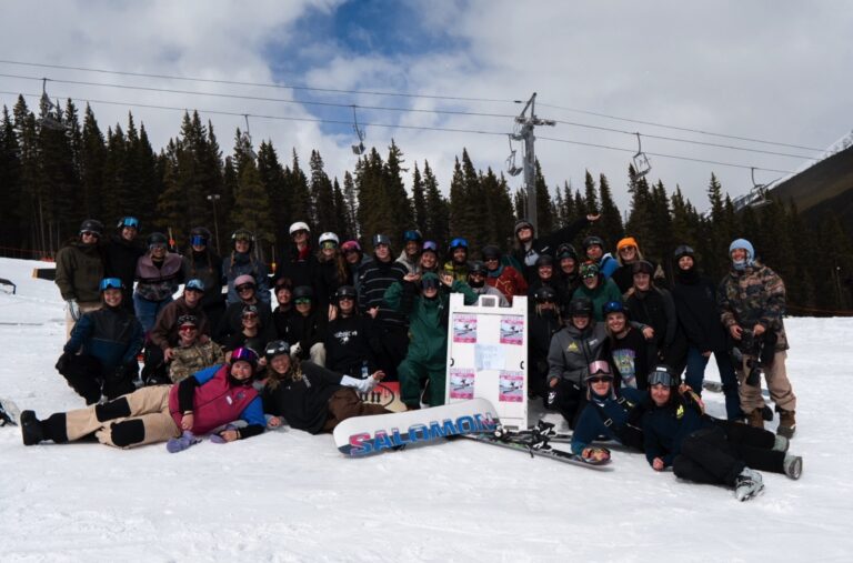 The full Quay Queens crew posing together at Norquay Ski Resort, Banff