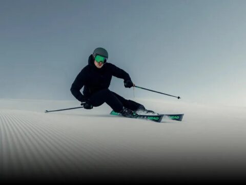Skier carving a groomed piste on HEAD Supershape skis