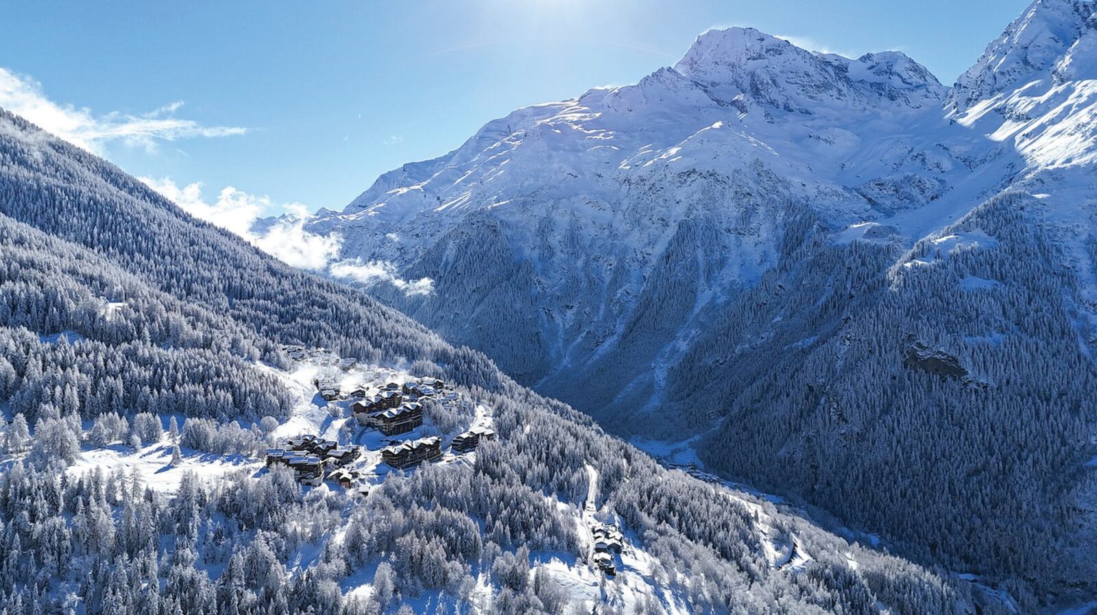 Aerial view of Sainte-Foy Tarentaise ski resort among snowy forest in the Tarentaise Valley, France